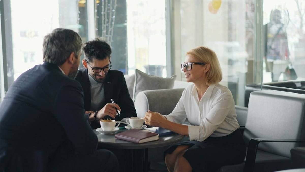Experienced professionals in suits meeting at a table